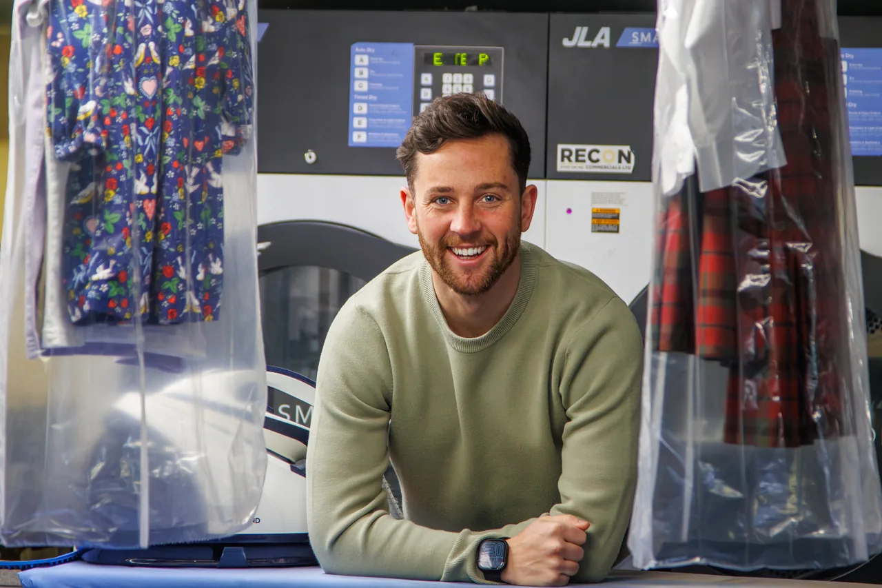 Sam, owner of Lovely Laundry, at the dry cleaning machine