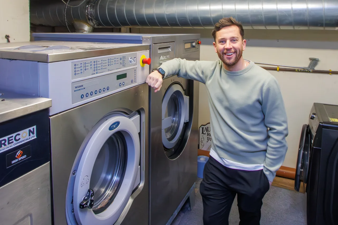 Sam beside the commercial washers